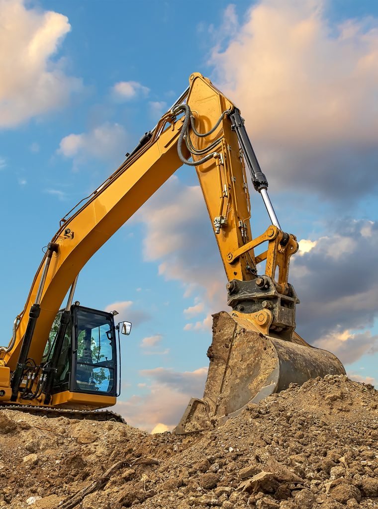 A stopping yellow excavator at stunning fluffy clouds